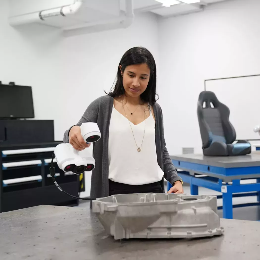 Studentka skanująca metalowy element skanerem 3D Creaform ACADEMIA w&nbsp;pracowni dydaktycznej